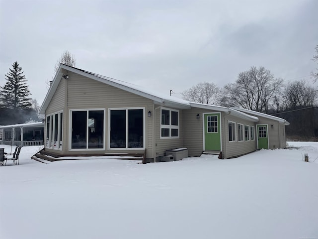 snow covered property with entry steps