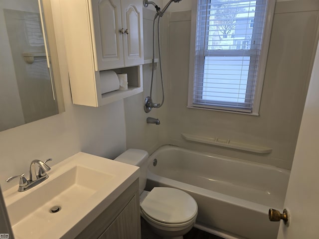 bathroom featuring bathing tub / shower combination, vanity, and toilet