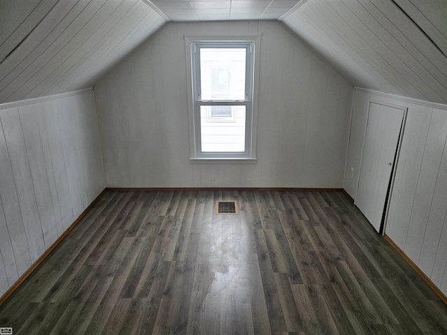 bonus room featuring vaulted ceiling, dark wood-type flooring, and visible vents