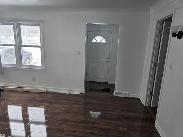 entryway featuring dark wood-style floors, baseboards, and visible vents