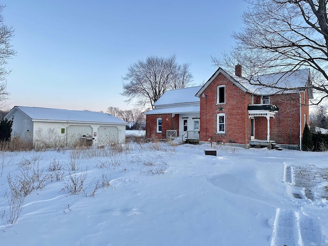 view of front of house featuring a chimney and brick siding