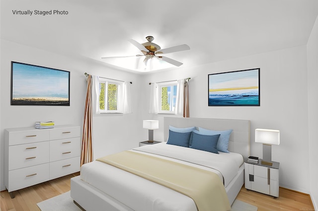 bedroom featuring light wood-style flooring and ceiling fan