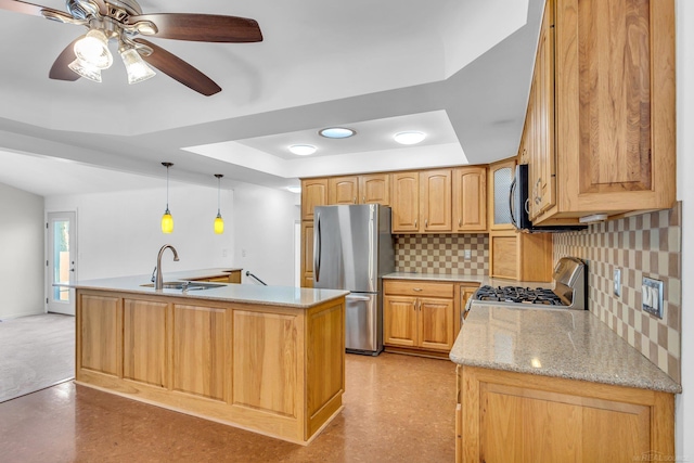 kitchen with stove, hanging light fixtures, freestanding refrigerator, decorative backsplash, and a tray ceiling