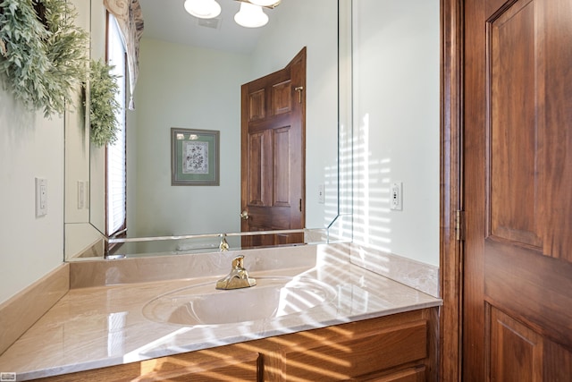 bathroom with vanity and an inviting chandelier