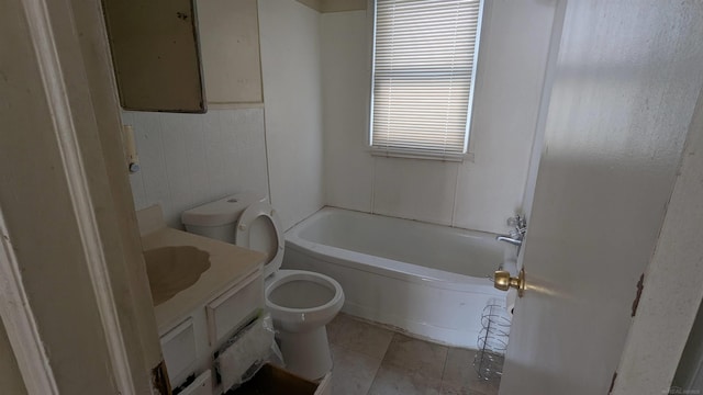 full bath featuring a tub to relax in, toilet, vanity, tile walls, and tile patterned floors