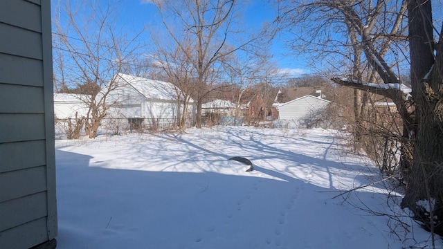 yard layered in snow featuring fence