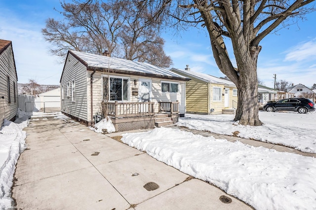 bungalow featuring fence and driveway