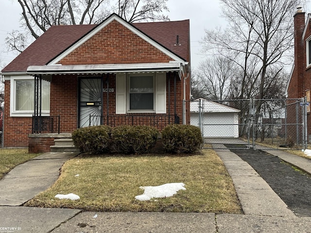 bungalow-style house featuring a porch, a gate, fence, a front lawn, and brick siding