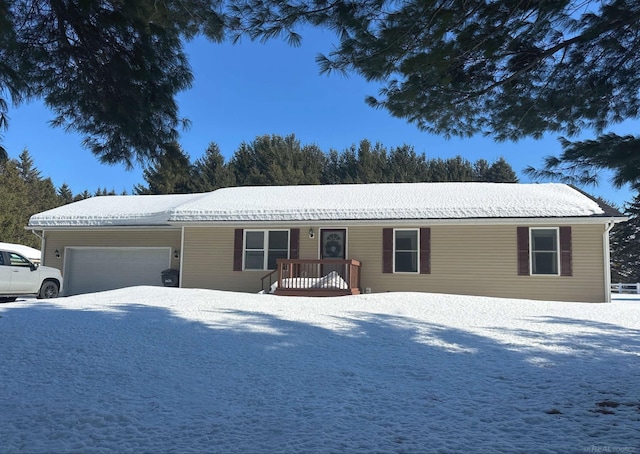 single story home with driveway and an attached garage