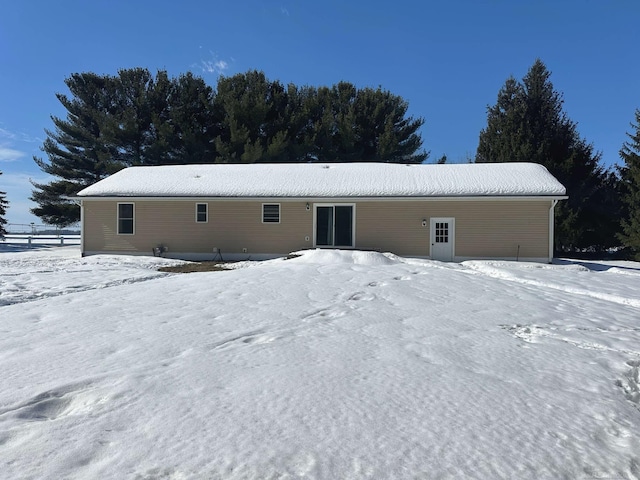 view of snow covered rear of property