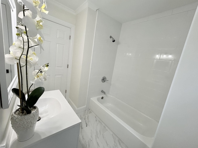 full bath with marble finish floor, ornamental molding, vanity,  shower combination, and baseboards