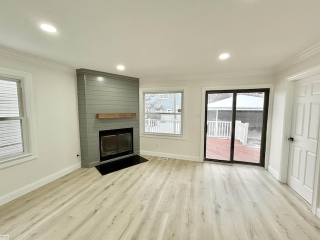 unfurnished living room featuring a large fireplace, baseboards, crown molding, light wood-style floors, and recessed lighting