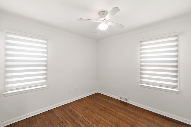 spare room with a ceiling fan, baseboards, visible vents, and hardwood / wood-style floors