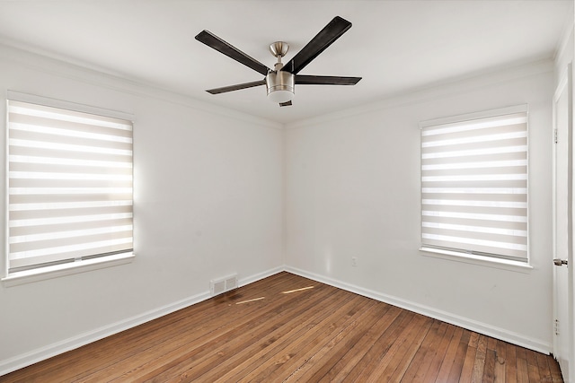 spare room with plenty of natural light, visible vents, hardwood / wood-style floors, and ornamental molding