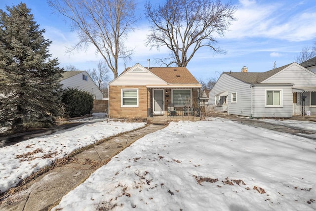 bungalow-style home with fence