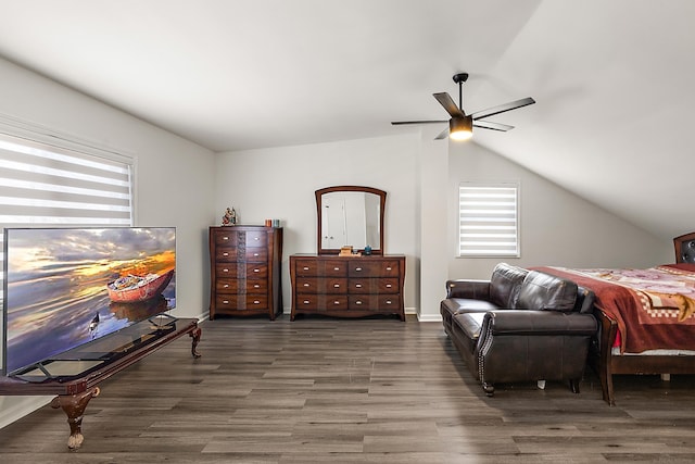 bedroom featuring lofted ceiling, ceiling fan, baseboards, and wood finished floors