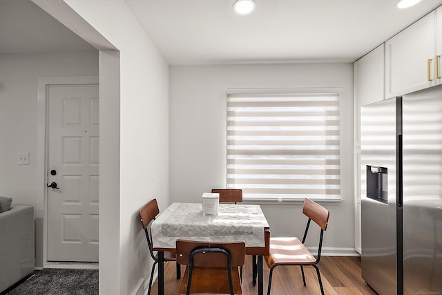 dining room featuring baseboards and wood finished floors