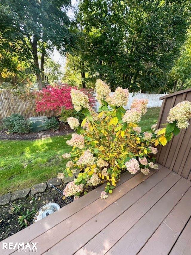 view of yard featuring fence and a deck