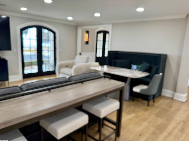 living area featuring french doors, light wood-style flooring, and recessed lighting