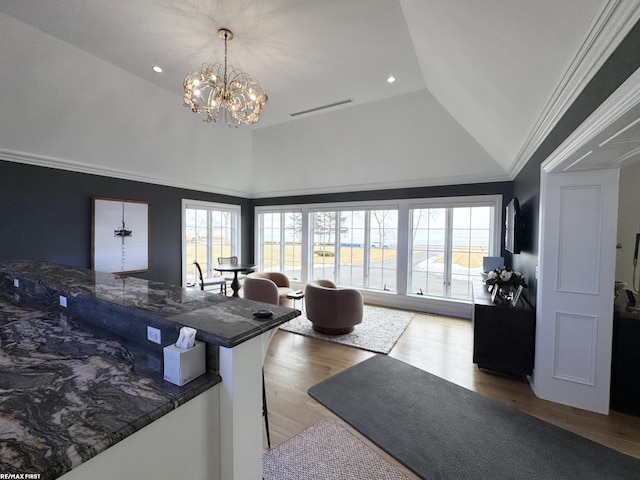 interior space featuring visible vents, crown molding, light wood-style flooring, and a healthy amount of sunlight