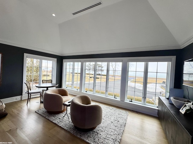 sunroom / solarium featuring visible vents and vaulted ceiling