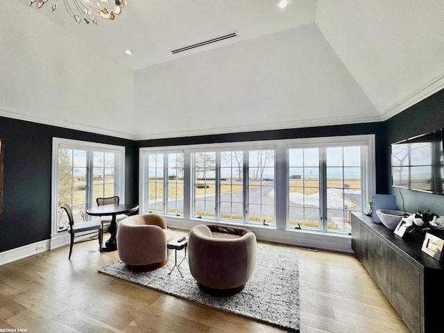 interior space featuring vaulted ceiling, visible vents, and a notable chandelier