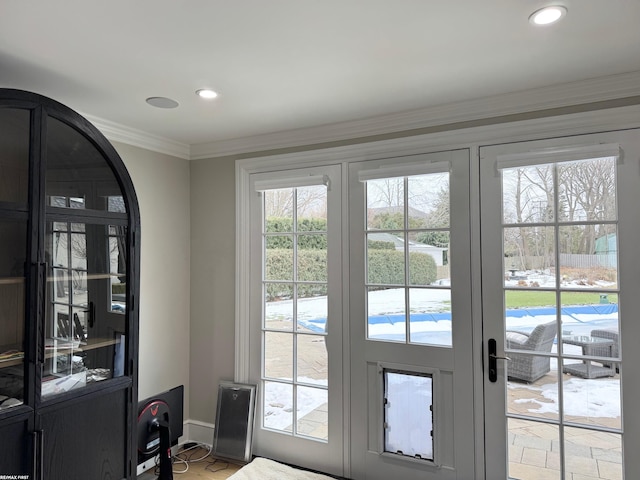 entryway featuring french doors, ornamental molding, and recessed lighting