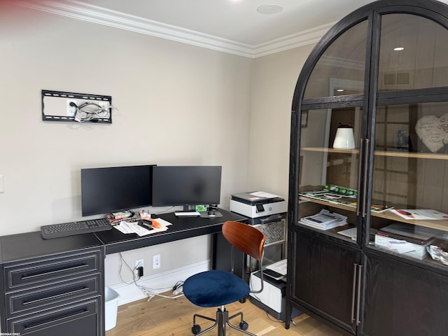 office area with light wood finished floors and crown molding