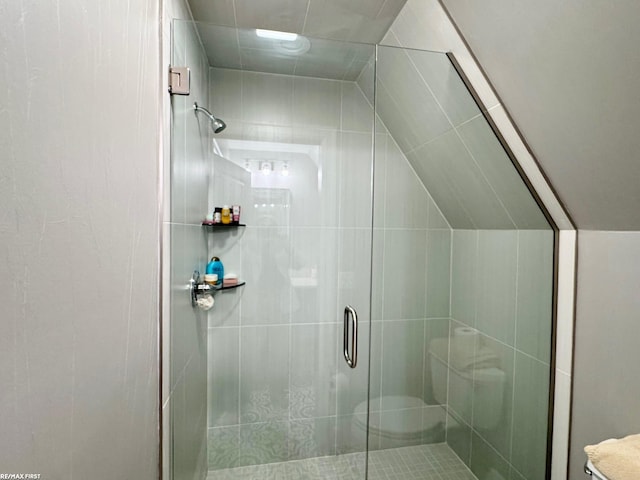 full bath with a stall shower and vaulted ceiling