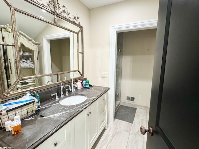 full bath featuring visible vents, vanity, and a shower stall