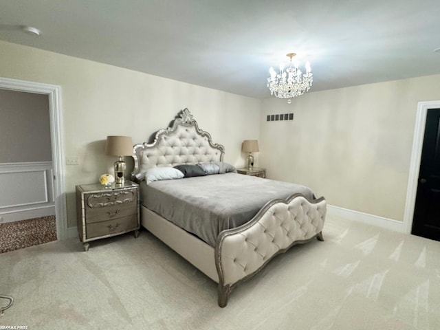 carpeted bedroom with baseboards, visible vents, and a notable chandelier