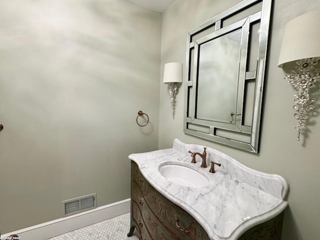 bathroom with visible vents, vanity, and baseboards