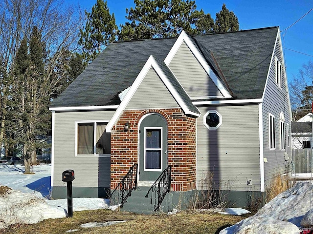 view of front of property featuring entry steps and brick siding