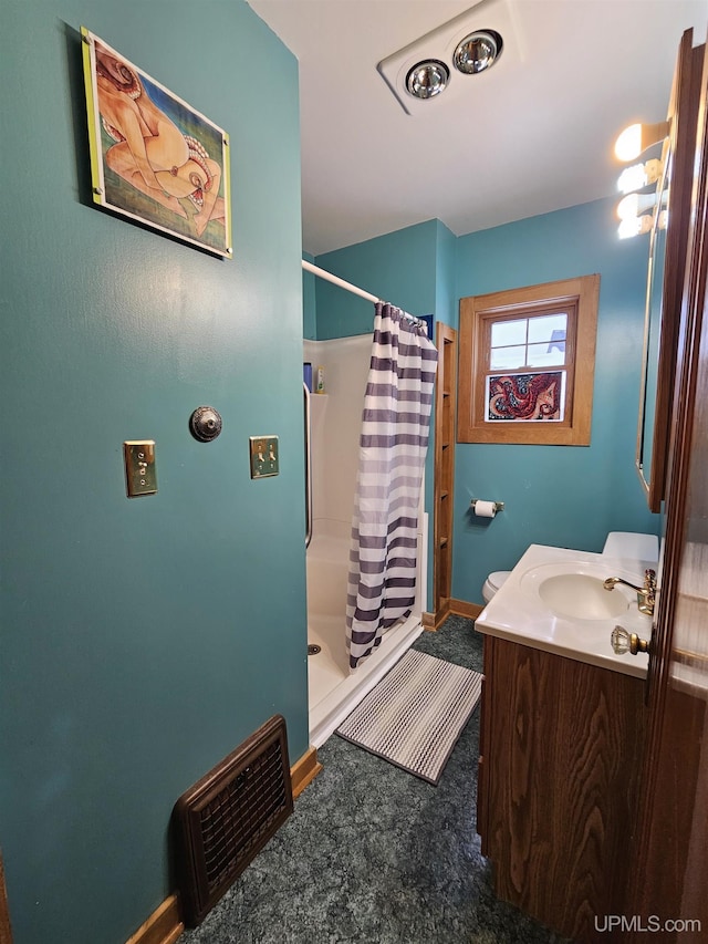 bathroom featuring a stall shower, baseboards, visible vents, and vanity