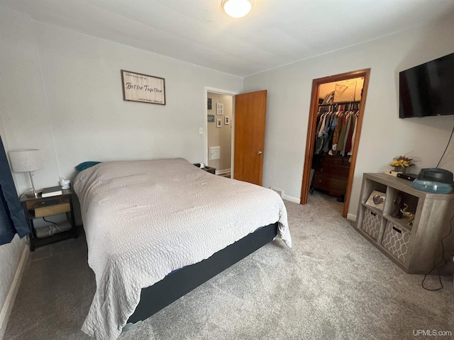 bedroom featuring carpet, a spacious closet, baseboards, and a closet