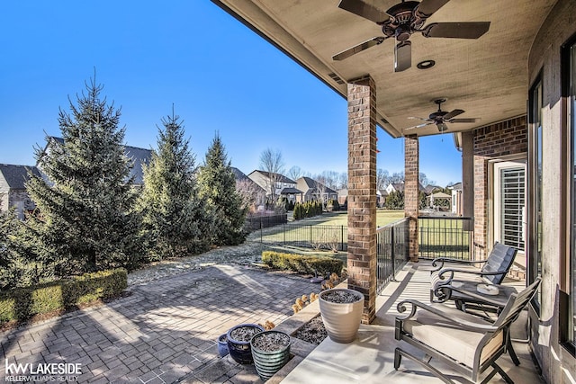 view of patio / terrace with a ceiling fan and fence