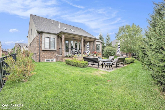 back of property featuring a yard, brick siding, a patio, and a fenced backyard