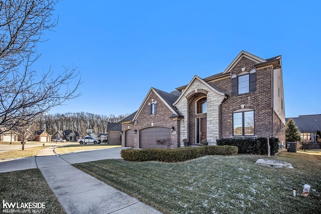 view of front facade featuring a garage, brick siding, driveway, stone siding, and a front lawn