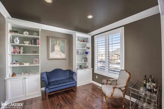 living area featuring dark wood-style floors, ornamental molding, built in shelves, and baseboards