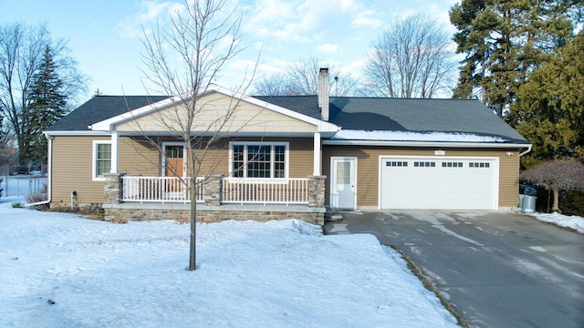 view of front of house featuring a garage, covered porch, driveway, and a chimney