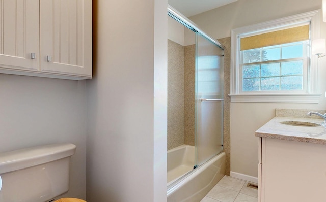 bathroom with visible vents, toilet, combined bath / shower with glass door, vanity, and tile patterned floors