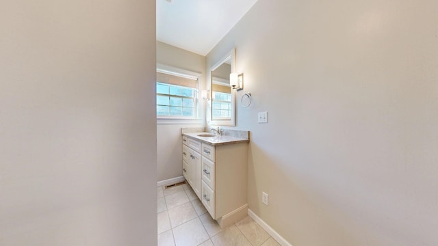 bathroom with baseboards, vanity, and tile patterned floors