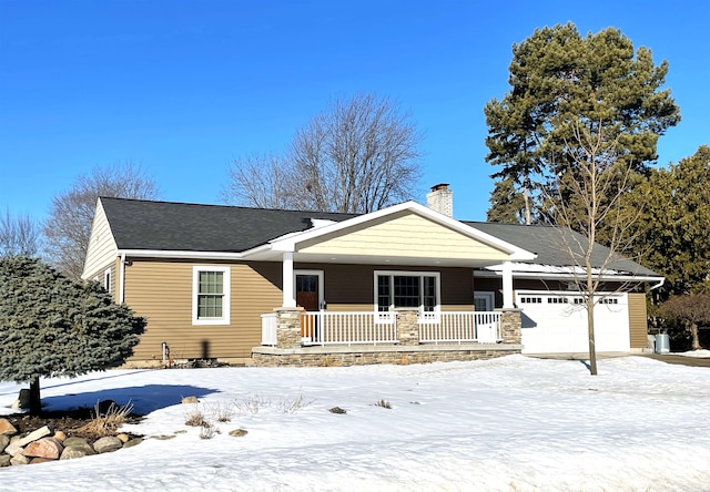 view of front of house featuring a garage, a chimney, and a porch