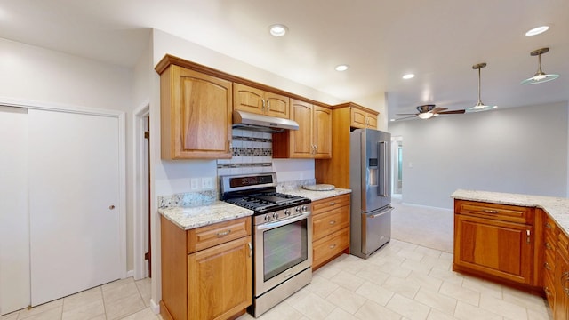 kitchen featuring stainless steel appliances, ceiling fan, under cabinet range hood, and light stone countertops