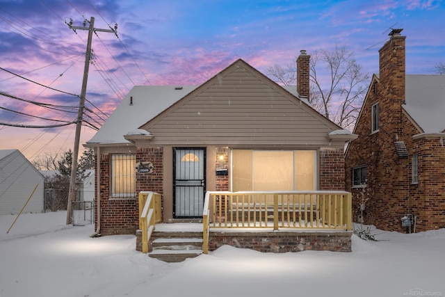 view of front facade with a porch and brick siding