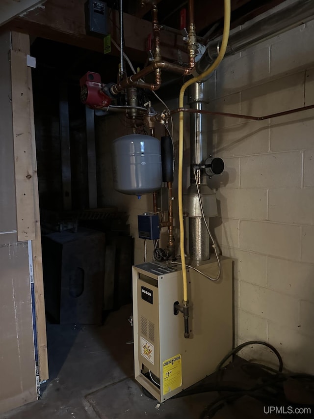 utility room featuring washer / dryer and a heating unit