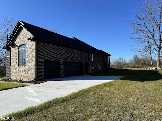 view of side of home with driveway, a yard, stone siding, and brick siding