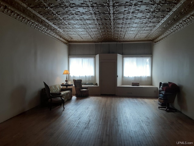 unfurnished room featuring an ornate ceiling, plenty of natural light, and hardwood / wood-style floors