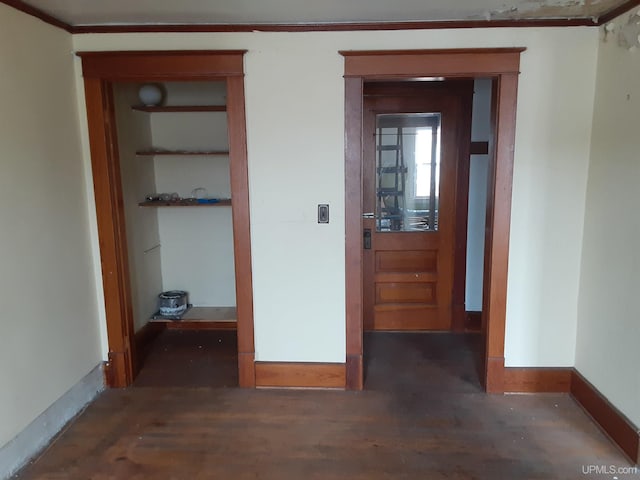 hallway featuring baseboards and wood finished floors