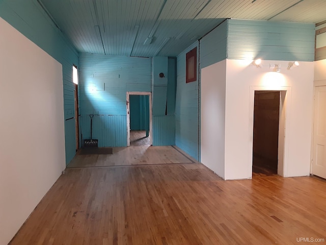 empty room with wooden ceiling and wood finished floors